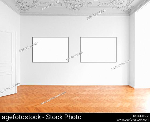 two blank picture frames hanging on white wall in empty room