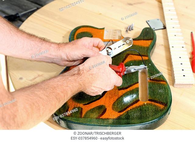 worker is building a guitar