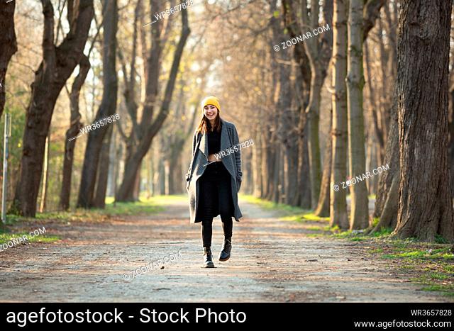 Young trendy woman walking on an avenue