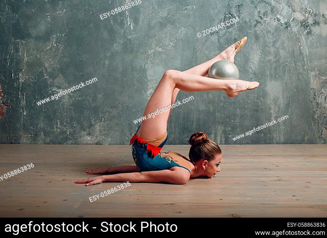 Young girl professional gymnast woman dance rhythmic gymnastics with ball at studio