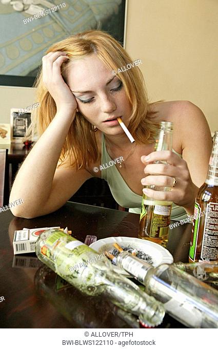 young woman drinking alcohol at a pub