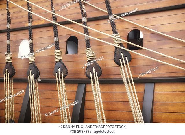 Detail of ropes and pulleys on the side of a historic sailing ship