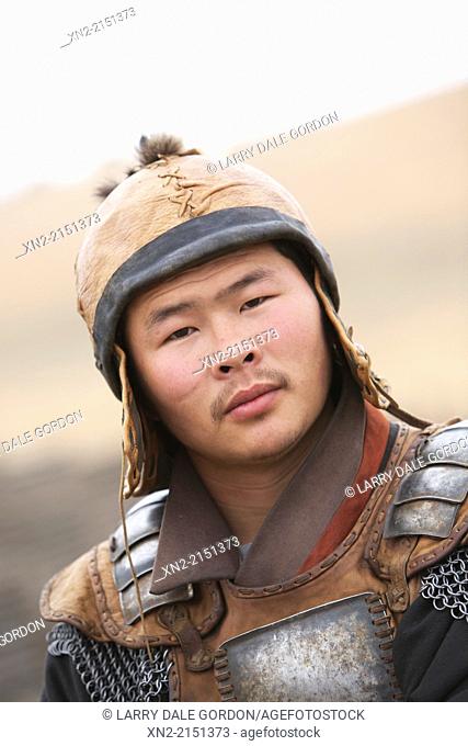Headshot of Mongolian man in traditional Genghis Khan warrior armor, 13th Century National Park, Tuv, Mongolia