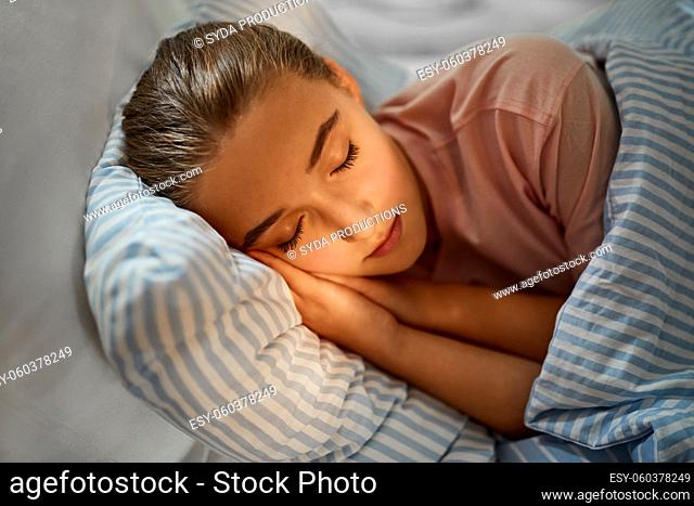 girl sleeping in bed at home