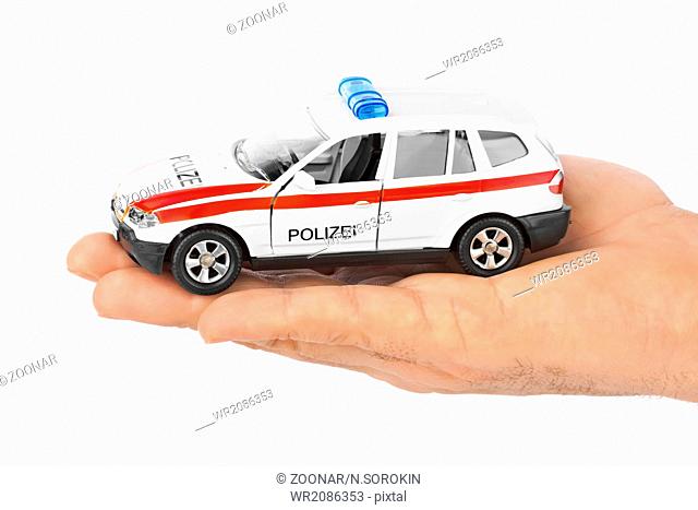 Hand with toy police car