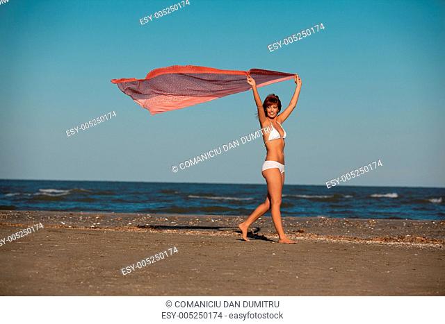 beautiful woman jumping for joy desert beach