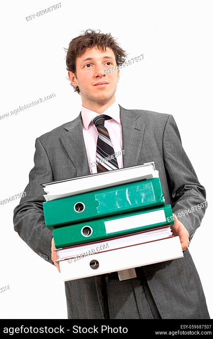 Tired young businessman carrying stack of folders. Isolated on white
