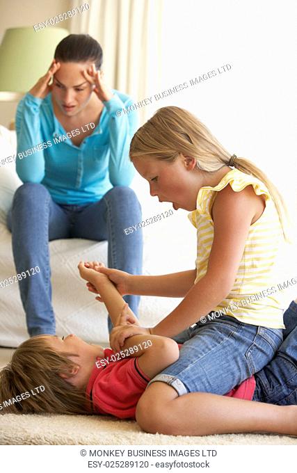 Children Fighting In Front Of Mother At Home
