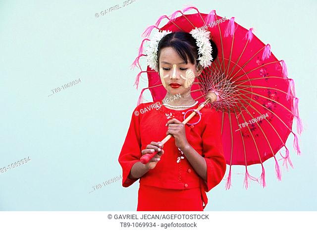 Myanmar, girl with traditional thanakha, a burmese sun cream favoured by woman and girls as a skin or anti- wrinkle cream