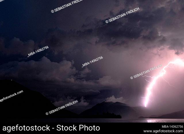 Thunderstorm with lightning strike at Walchensee, in the background the peninsula Zwergern, Jochberg and Estergebirge