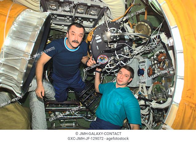 Cosmonaut Mikhail Tyurin (left), Expedition Three flight engineer, and Soyuz Taxi crewmember, Flight Engineer Konstantin Kozeev
