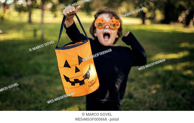 Masquerade little girl holding halloween lantern
