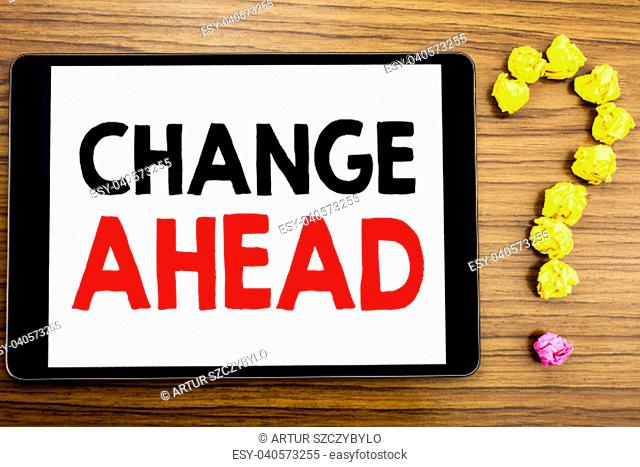 Writing text showing Change Ahead Red Word. Business concept for Future Changes written on tablet computer on wooden background with question mark made of...