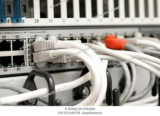 network hub and cables connected to servers in a datacenter