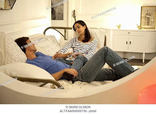 Couple relaxing together on bed