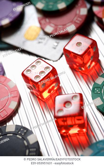 Casino chips and dices on a metal surface