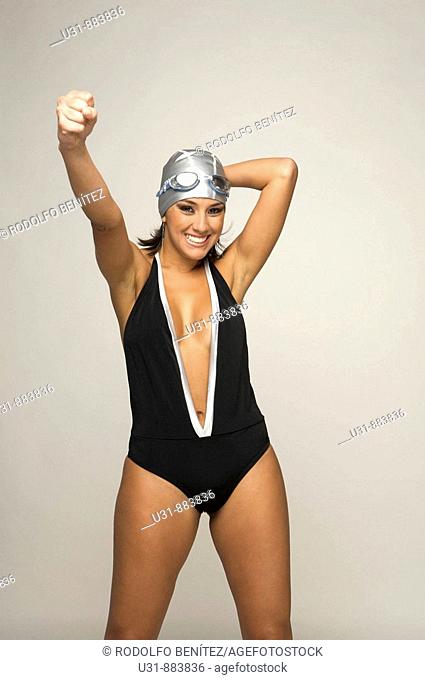Trendy model in a swimsuit celebrates