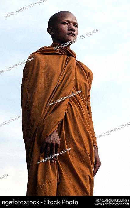 Siem Reap, Cambodia - January 19, 2011: A monk in his orange robe inside the Angkor Wat complex