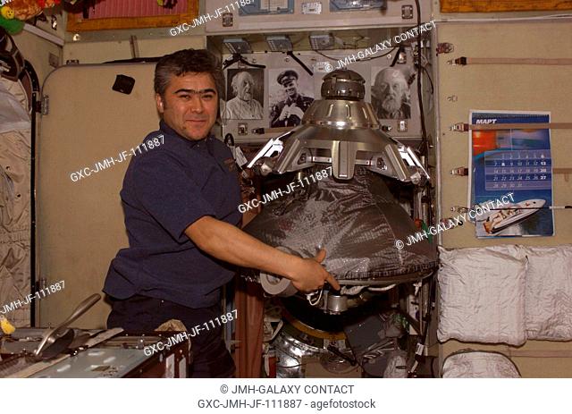 Cosmonaut Salizhan S. Sharipov, Expedition 10 flight engineer representing Russia's Federal Space Agency, holds the Progress supply vehicle probe-and-cone...
