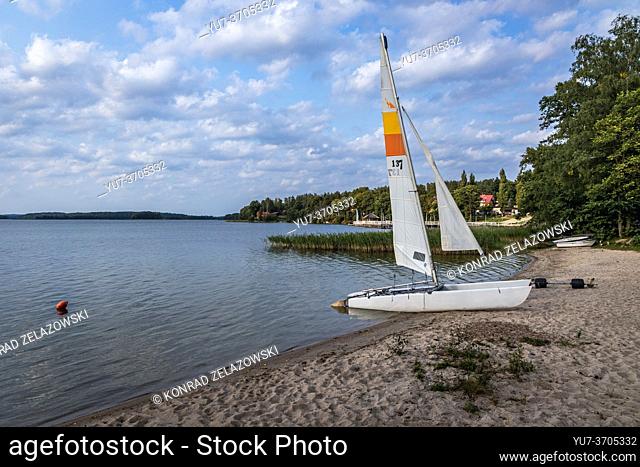 Catamaran over Narie Lake located in Ilawa Lakeland region, view from Kretowiny village, Ostroda County, Warmia and Mazury province of Poland