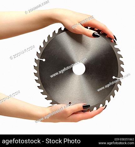 Female hands with black nails manicure with circular saw blade. Isolated on white background