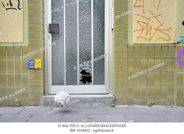 Shot pane of a door and football, Germany, Europe