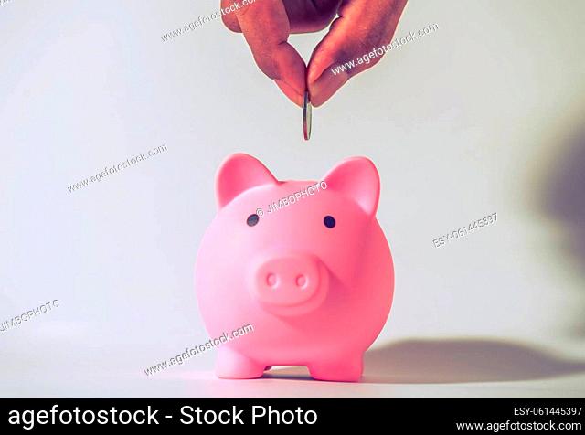 Save money and account banking for finance concept, Hand with piggy bank and coin on blurred background, Save Monney for Investors Using Internet to Trade...
