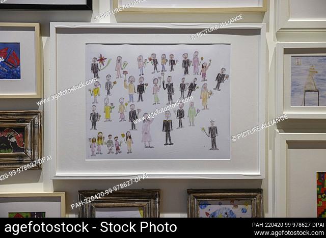 PRODUCTION - 21 March 2022, Saxony, Leipzig: ILLUSTRATION: A child's drawing in which all male adults are dressed in black hangs in the Childhood House