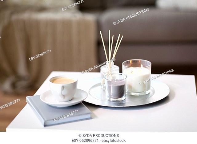 coffee, candles and aroma reed diffuser on table