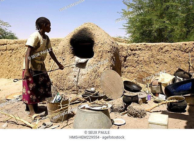 Mali, Niger River banks, woman making bread herself