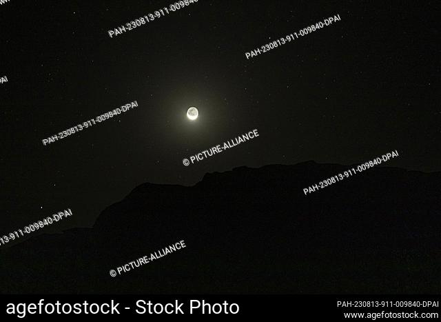 12 August 2023, Egypt, Faiyum: A Picture taken on 12 August shows the moon over the natural reserve area of Wadi Al-Hitan (Valley of the Whales) at the desert...