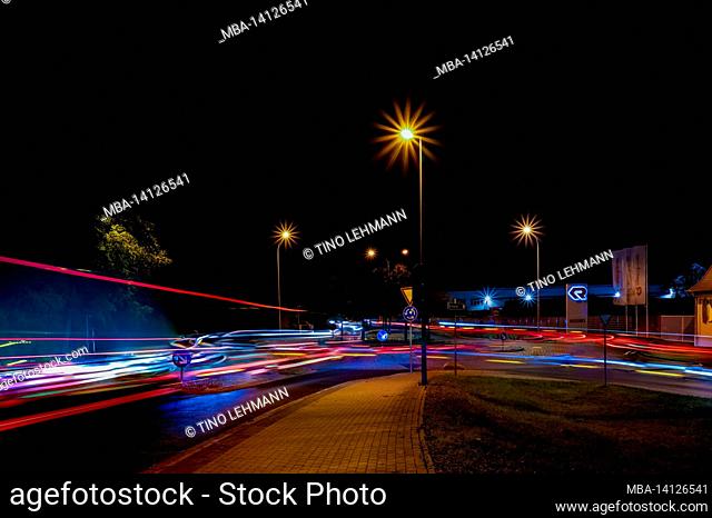 light traces of cars at night in the city of luckenwalde in germany