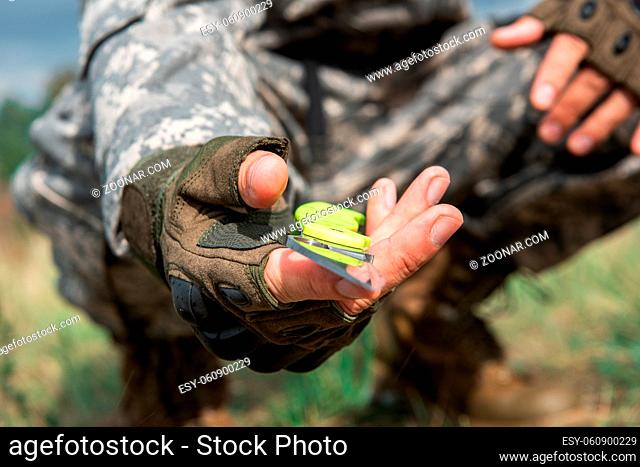 A man with a knife in the forest. Travel or military concept