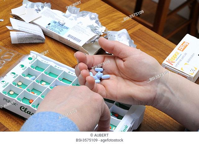 Independent nurse, in Vénissieux, France. Preparation of a pill box at a patient's place