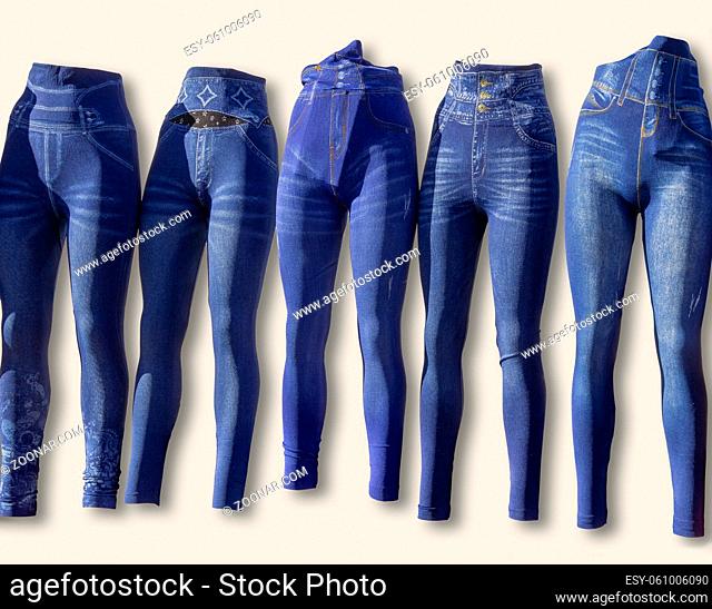 some pairs of blue jeans-like leggings in front of light back