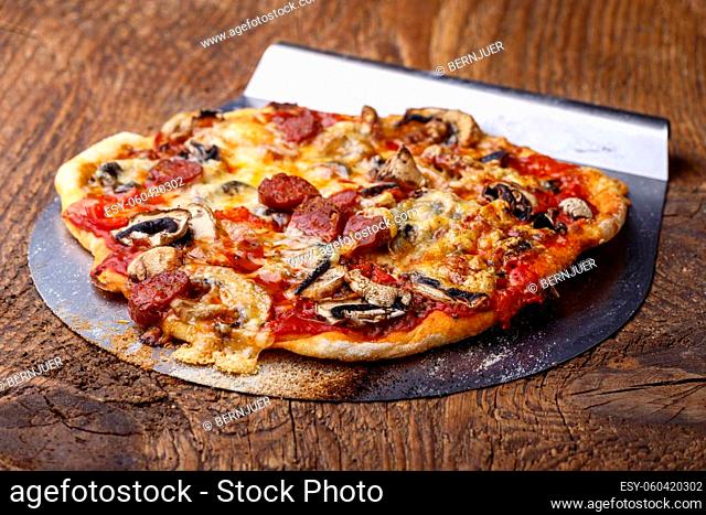 pizza with lifter on wood