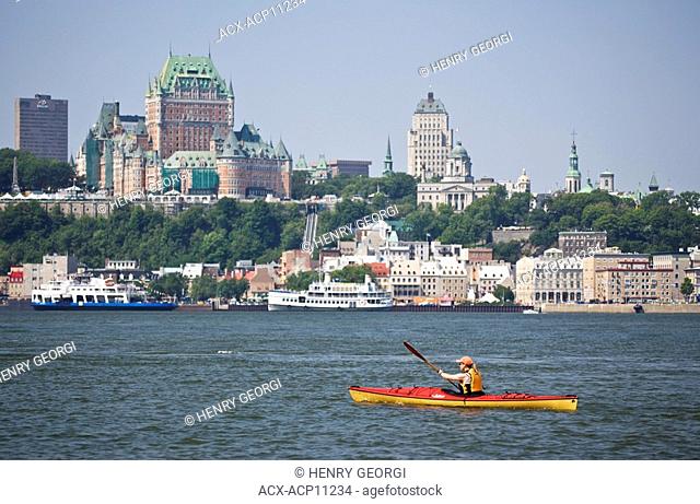 Young woman sea kayaking in the St Lawrence River near Quebec City, Quebec, Canada