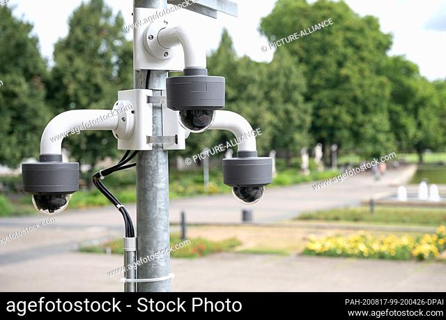 17 August 2020, Baden-Wuerttemberg, Stuttgart: Security cameras are mounted on a pole in front of the Ministry of Finance in the direction of Eckensee
