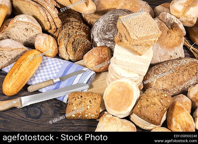 Fresh Assortment of several baked bread varieties on a wooden table