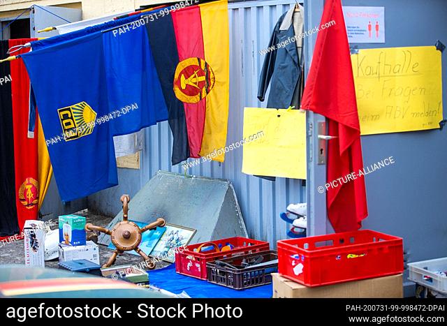 24 July 2020, Saxony-Anhalt, Beuster: Flags and objects from the GDR will be offered for sale or exchange on the Blue Light Days in the Blue Light Museum...