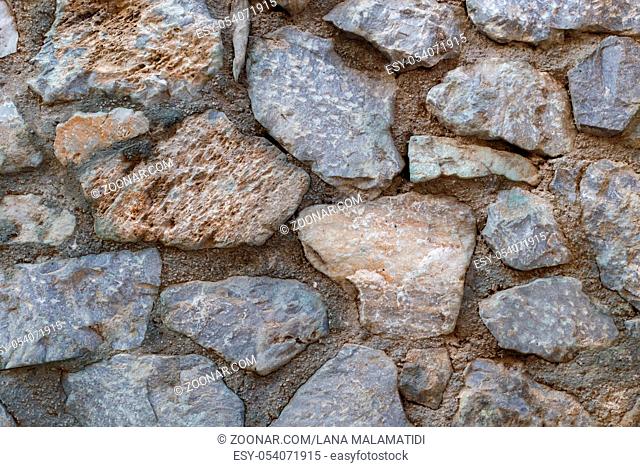 Natural stone wall texture, old streets of greece