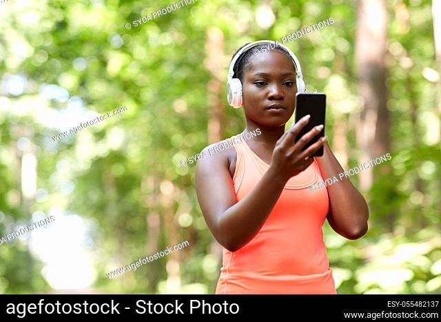 african american woman with headphones and phone