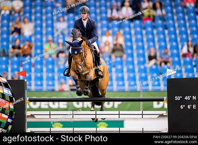 27 June 2023, North Rhine-Westphalia, Aachen: Equestrian sports, jumping: CHIO, Opening Jumping. Rider Ben Maher from Great Britain on the horse ""Enjeu de...