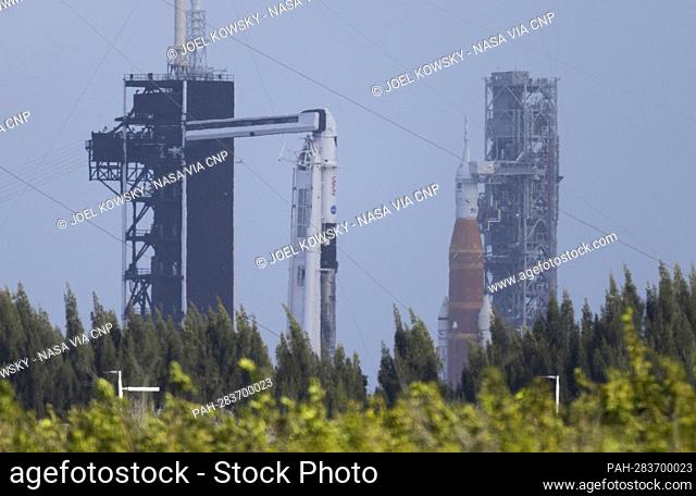 NASA’s Space Launch System (SLS) rocket with the Orion spacecraft aboard is seen atop a mobile launcher at Launch Complex 39B, right