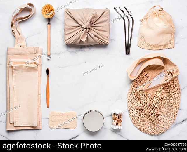 Zero waste concept. Textile wrapping gift, eco bags, metal straws, eco-friendly kitchen tools, bamboo toothbrush and cotton buds
