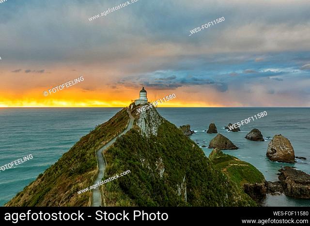 New Zealand, Oceania, South Island, Southland, Otago, Southern Scenic Road, Cape Nugget Point, Nugget Point Lighthouse at sunrise