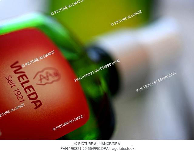 23 July 2019, Baden-Wuerttemberg, Schwäbisch Gmünd: The company logo of Welede is on a glass bottle. Weleda produces herbal medicines and cosmetics
