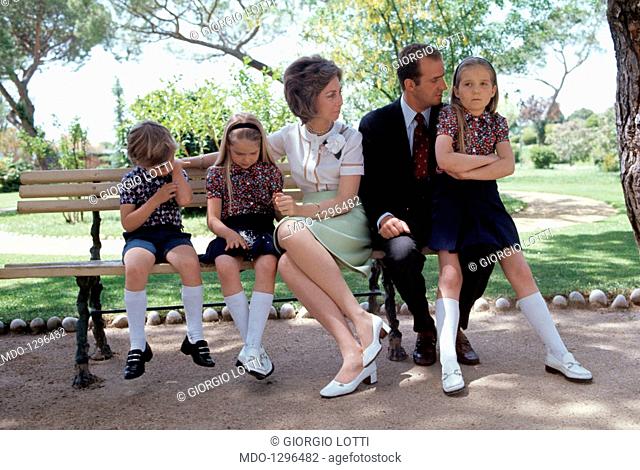 El príncipe Juan Carlos de Bourbon se sentó con su familia en un banco del parque. Retrato de la familia del futuro rey de España en un banco de la villa La...