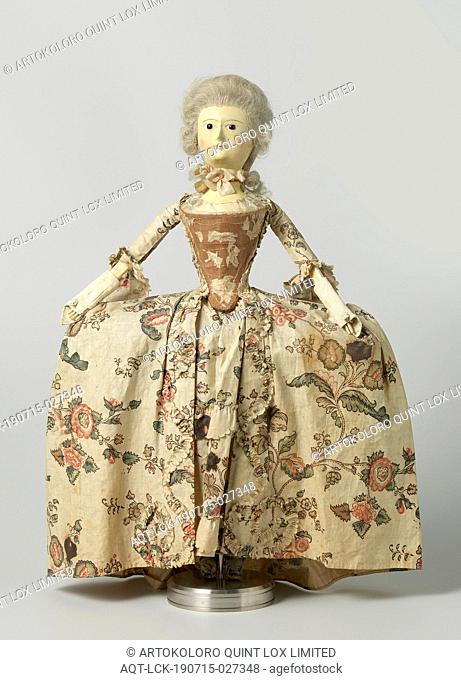 Wooden doll with glass eyes and human hair, dressed in a demi-parure of floral sits, consisting of an overcoat and a tablier
