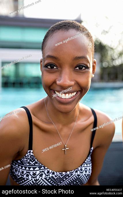 Smiling woman wearing bikini at resort